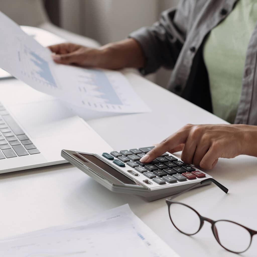 Woman accountant using calculator and computer in office panoramic banner, finance and accounting concept